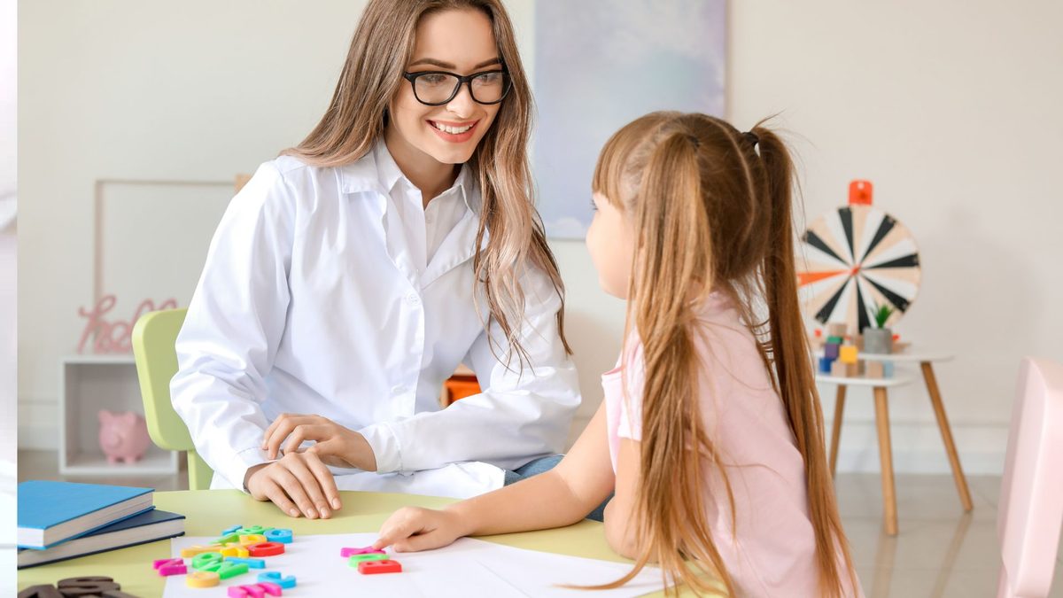 Psychologist working through letter games with a young girl